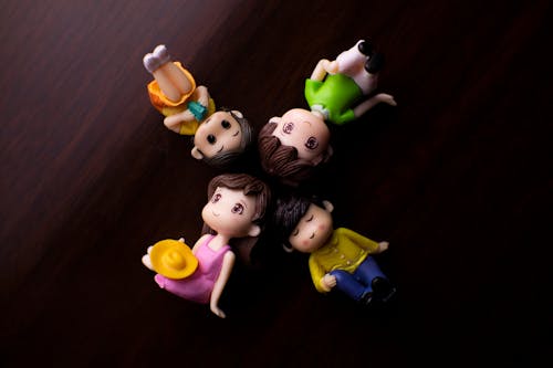 Free Small figurines on wooden table Stock Photo