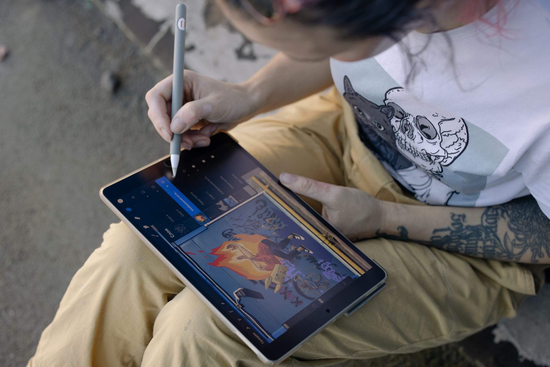 Person in White Shirt Holding Gray Stylus and Black Digital Tablet