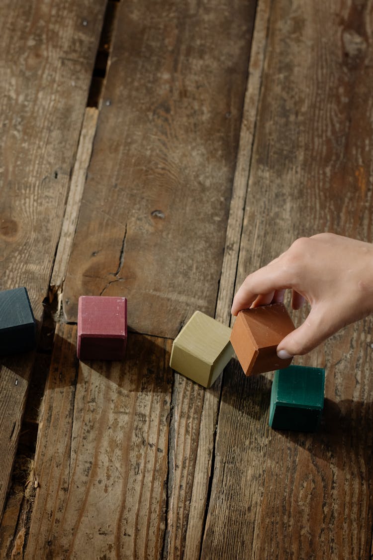 A Kid Holding Wooden Blocks