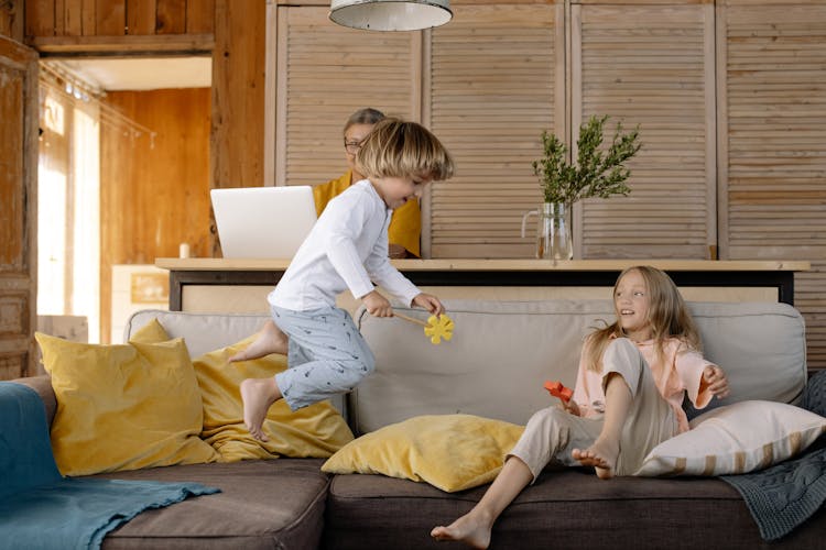 Children Playing On Sofa 