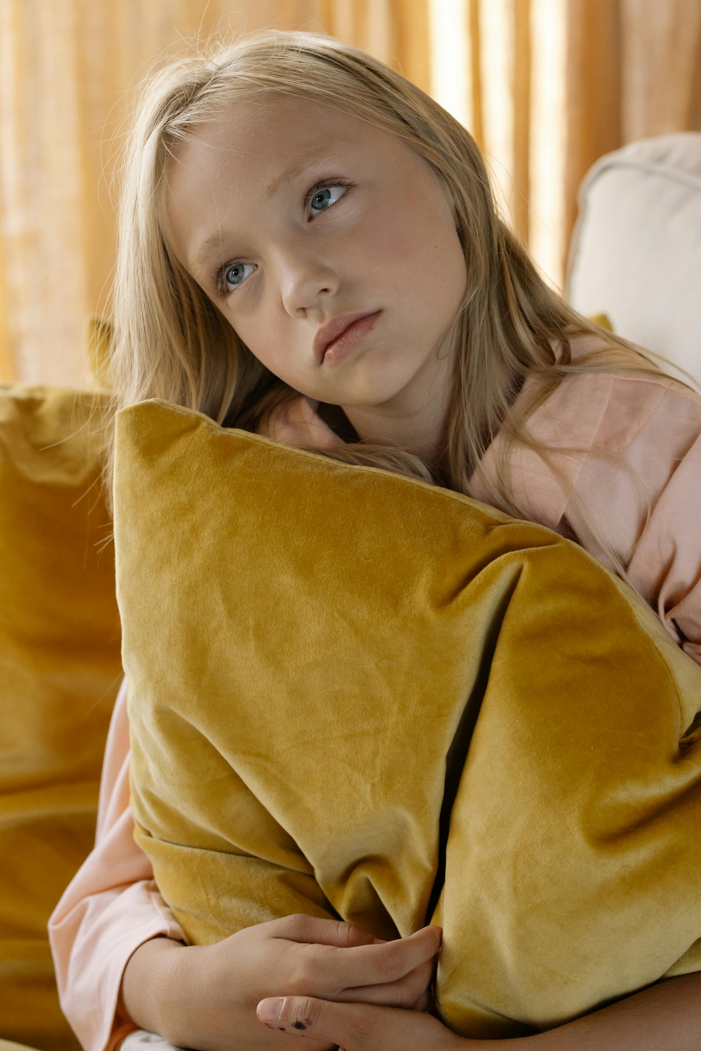 Girl Hugging a Pillow · Free Stock Photo