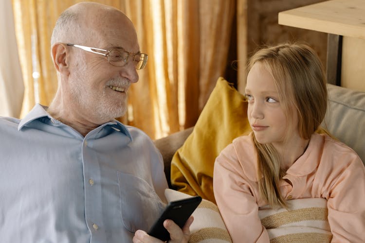 Elderly Man Sitting With A Girl 