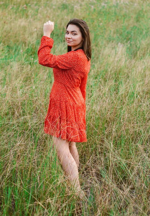 Smiling Woman in a Summer Dress on a Field 