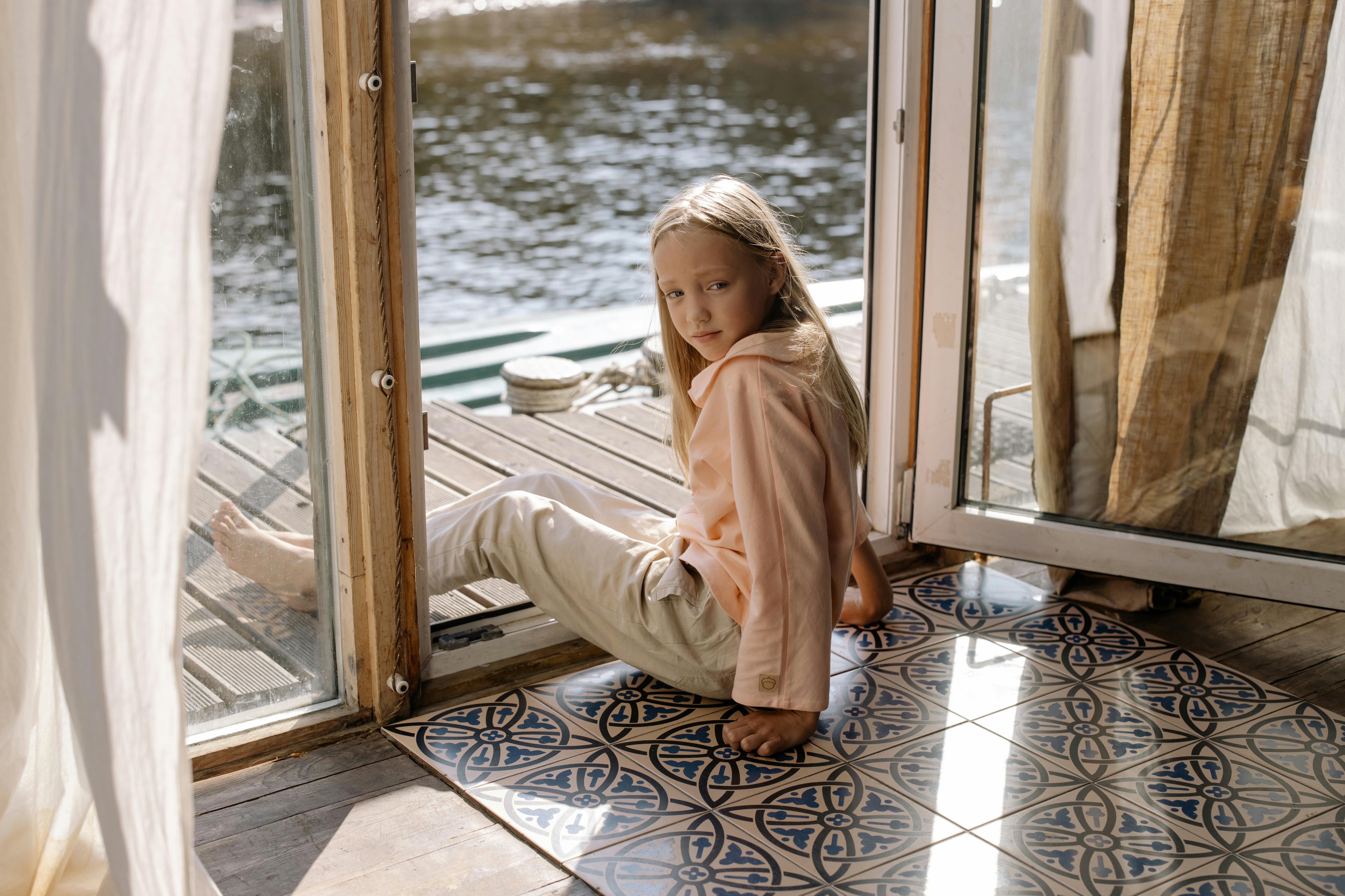 cute girl sitting on the doorway