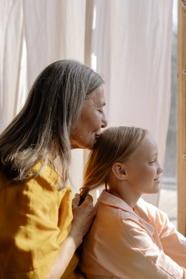 Elderly Woman Kissing A Girl