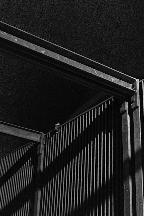 Metal fence with shadows at night