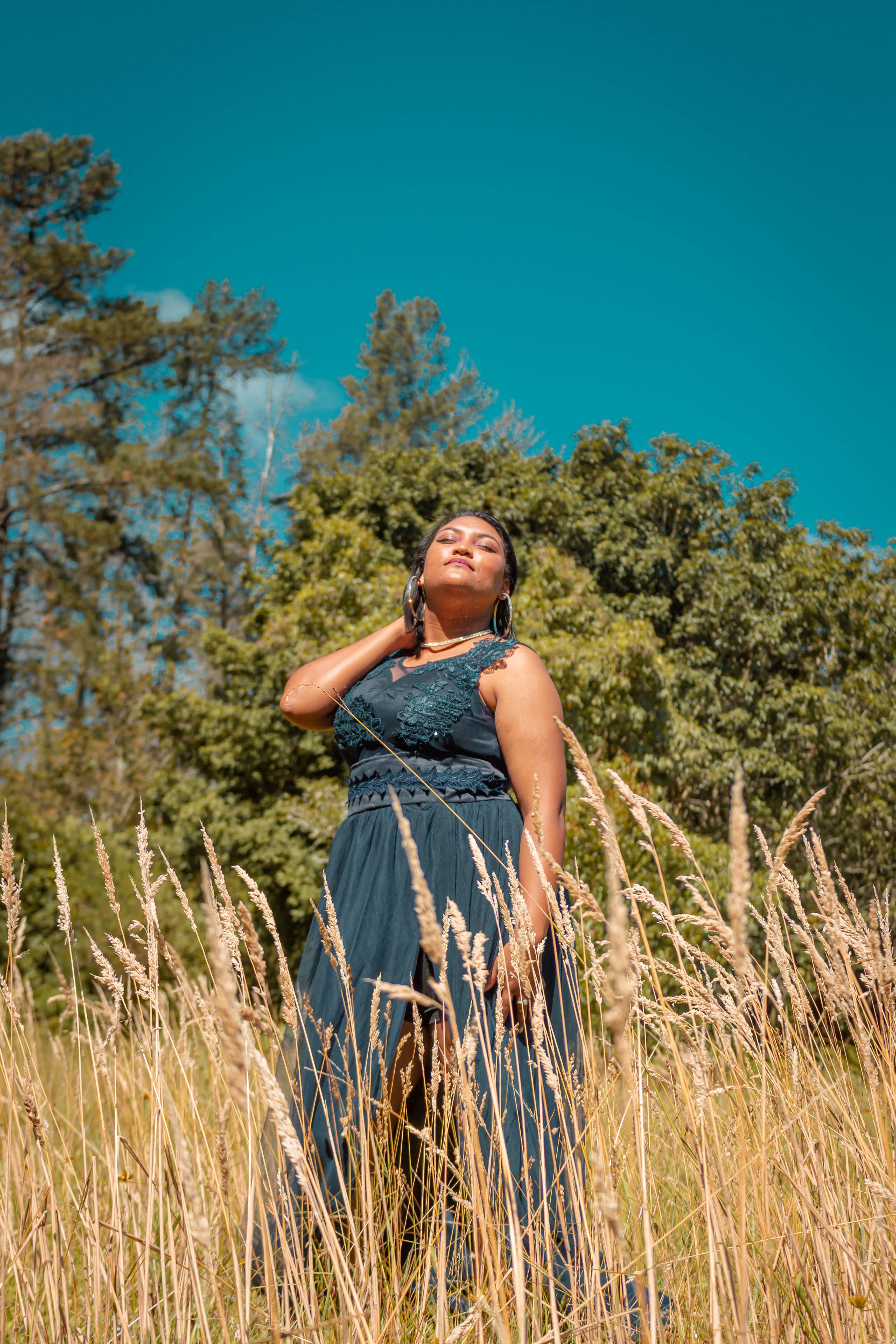 Woman in Blue Dress Standing on Brown Grass Field · Free Stock Photo