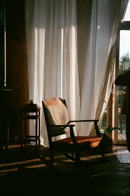 Armchair Near Window With White Curtain