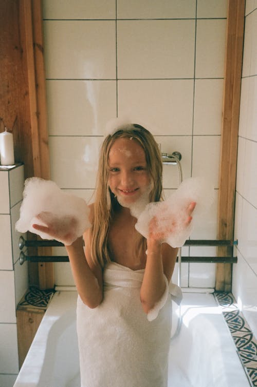 Photograph of a Girl Playing with Bubbles