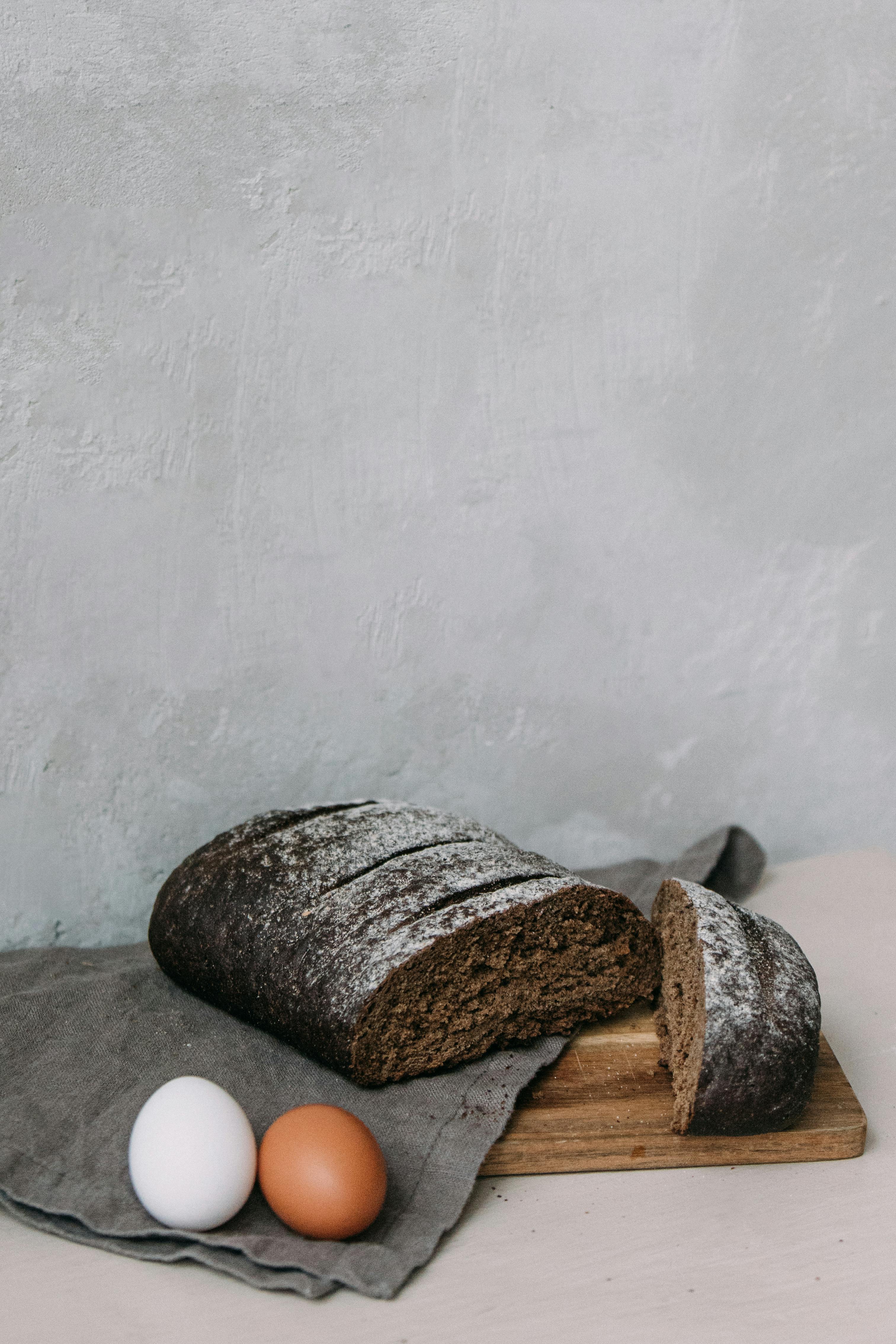 Bread and Eggs on Table Napkin on Chopping Board