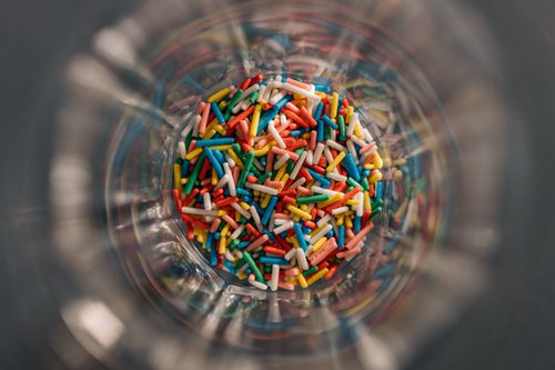 Free A top view image of colorful sprinkles in a glass bowl, capturing vibrant details. Stock Photo