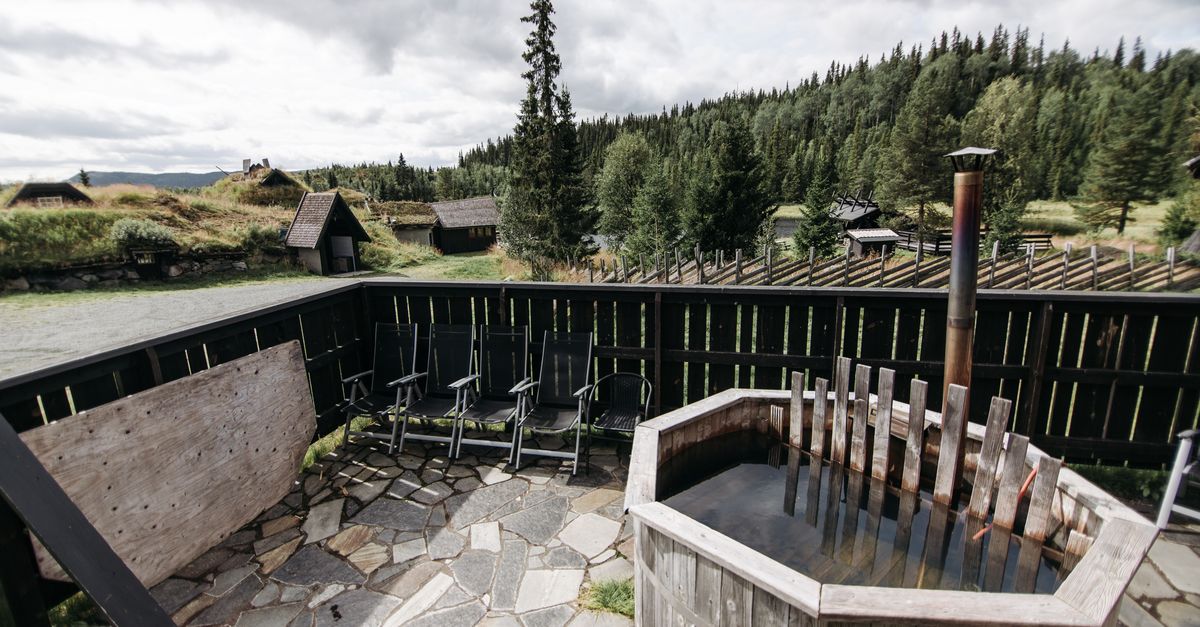 misty mountain hot spring sunrise, rustic wooden soaking tub, volcanic mountain landscape, alpine river hot spring