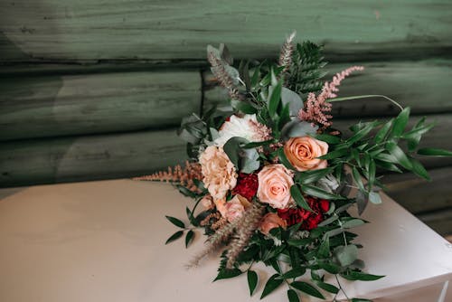Photo of a Bouquet of Flowers with Roses and Green Leaves