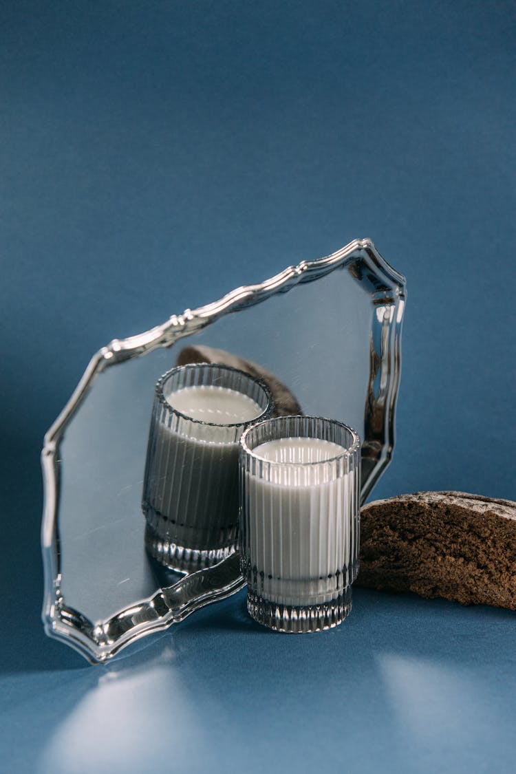 A Glass Of Milk Beside A Silver Tray