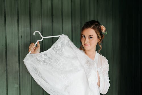 A Woman Holding Her Wedding Dress 