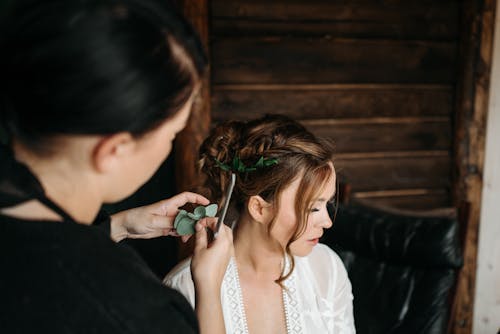 A Hairdresser Styling the Bride's Hair