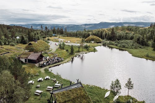 Aerial Photography of People Gathered Together in front of a Wooden House