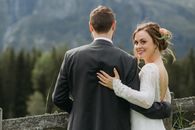 A Beautiful Bride Smiling at the Camera while Standing Beside Her Groom