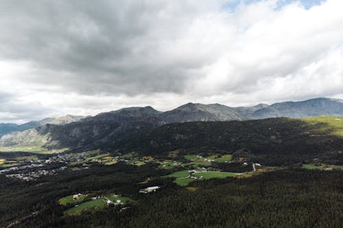 View of Landscape with Trees Under Cloudy Sky