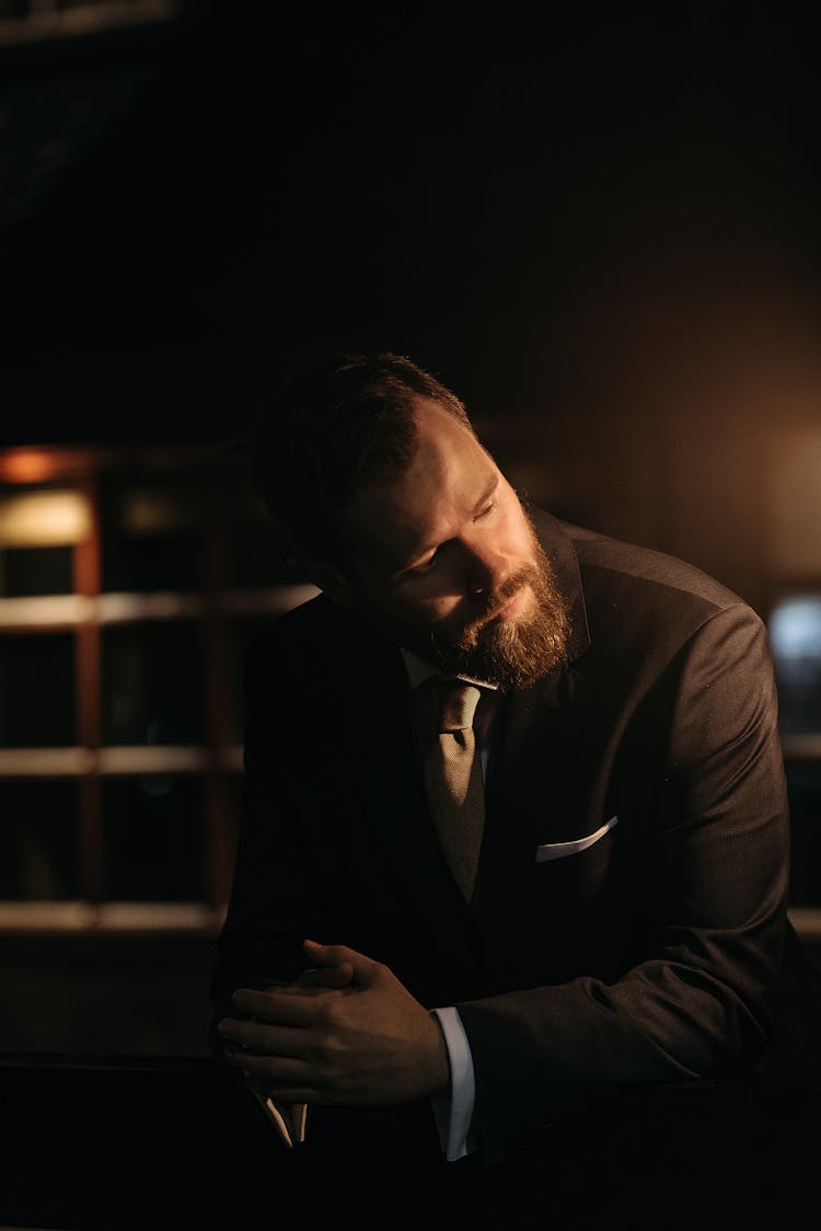 Close Up Photo Of Bearded Man In Black Suit