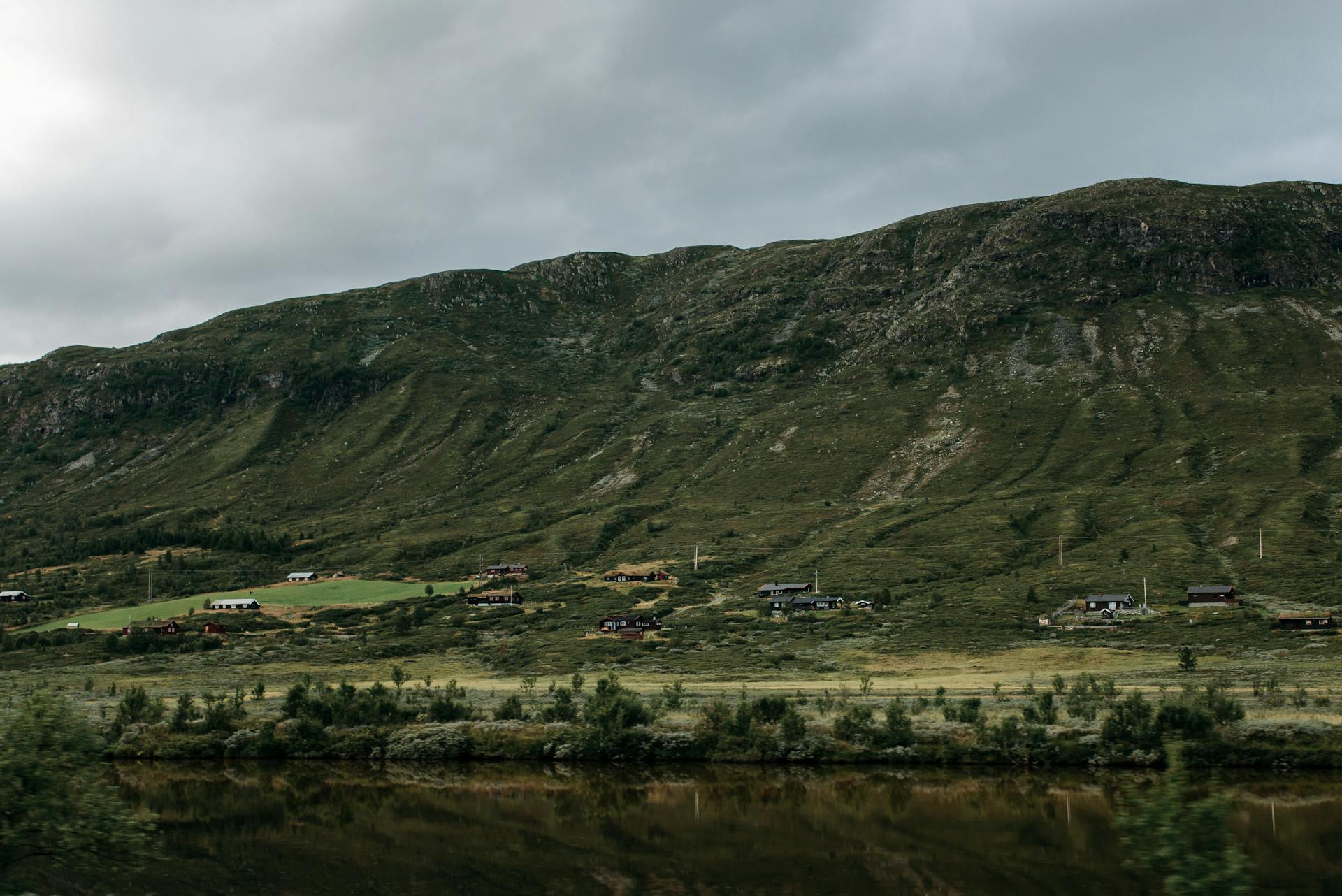 Beautiful mountain landscape with small houses and a cloudy sky, capturing the essence of nature.