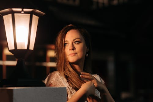 Woman Standing beside Black Lantern