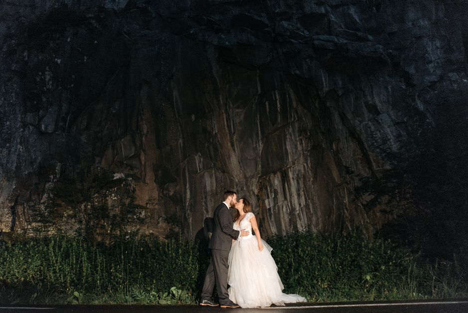 Woman in White Wedding Gown Kissing Man in Black Suit