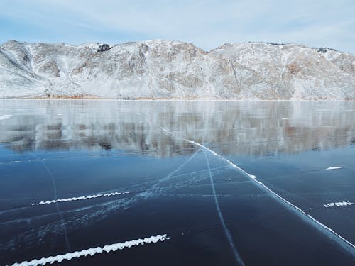 A Snow-Covered Mountain near a Frozen Lake