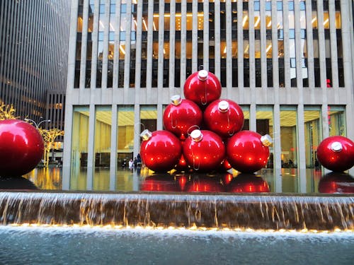 Free Red Baubles Near Grey High-rise Building Stock Photo
