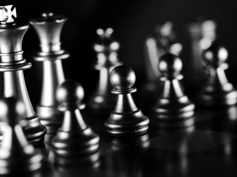 Detailed monochrome image of chess pieces, showcasing strategy and focus.