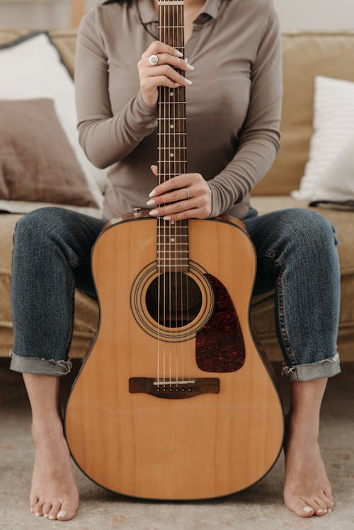 A Person Holding an Acoustic Guitar