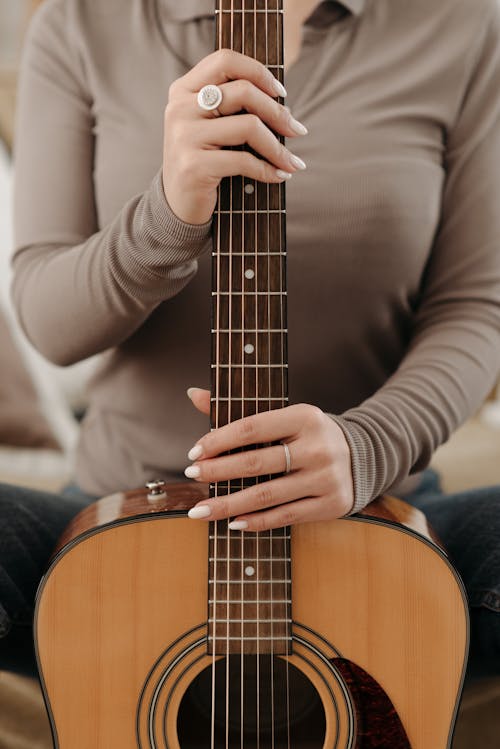 A Person Holding an Acoustic Guitar