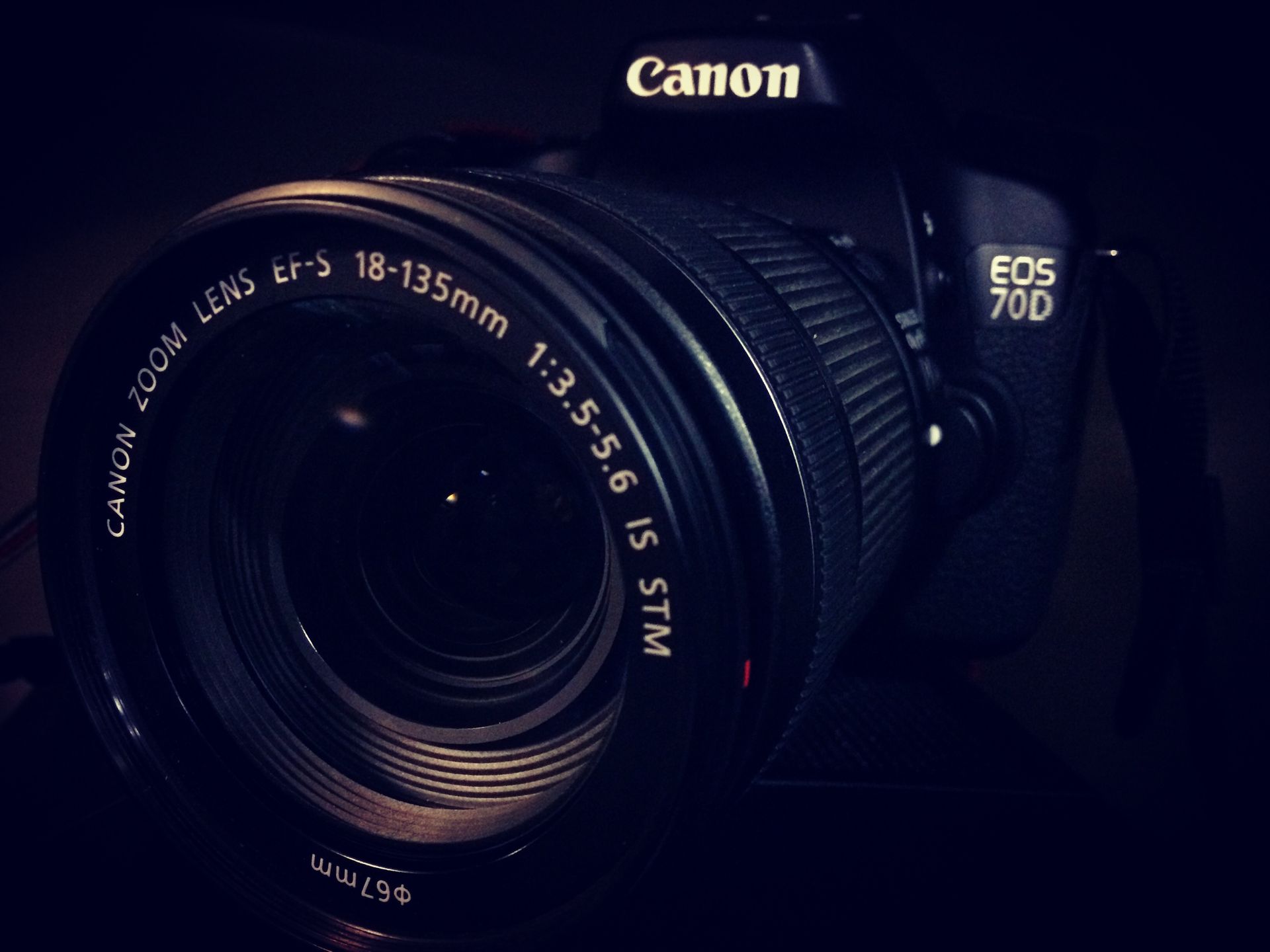 Detailed close-up of a professional DSLR camera lens with reflections and focus settings.