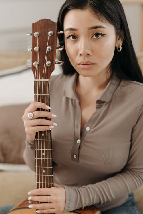 Woman Holding a Guitar 