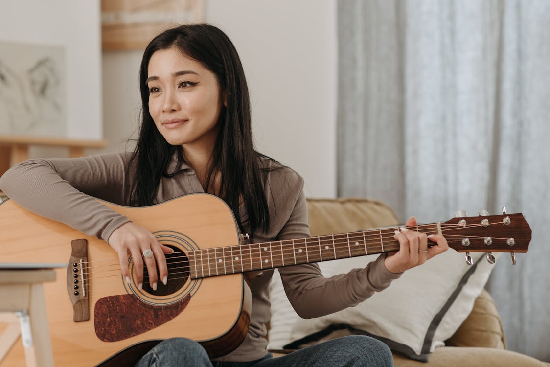 Free Woman Playing a Guitar Stock Photo