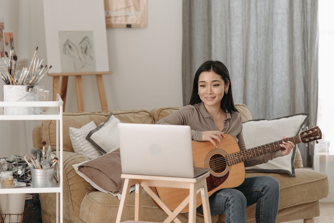 Woman Learning How to Play a Guitar