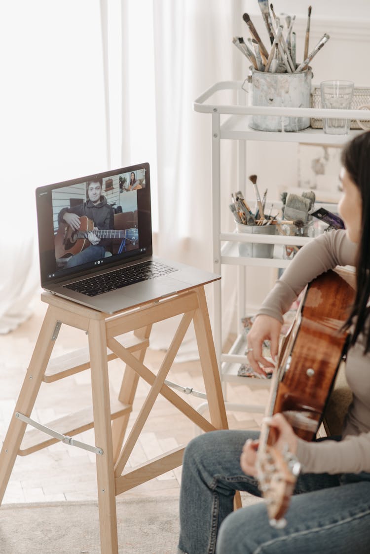 Woman Learning How To Play A Guitar