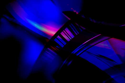 Vivid abstract image capturing dynamic neon light reflections and shadows in bold colors.