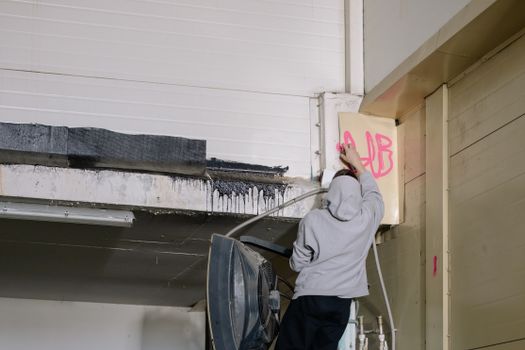 Back View of a Person Doing Vandalism