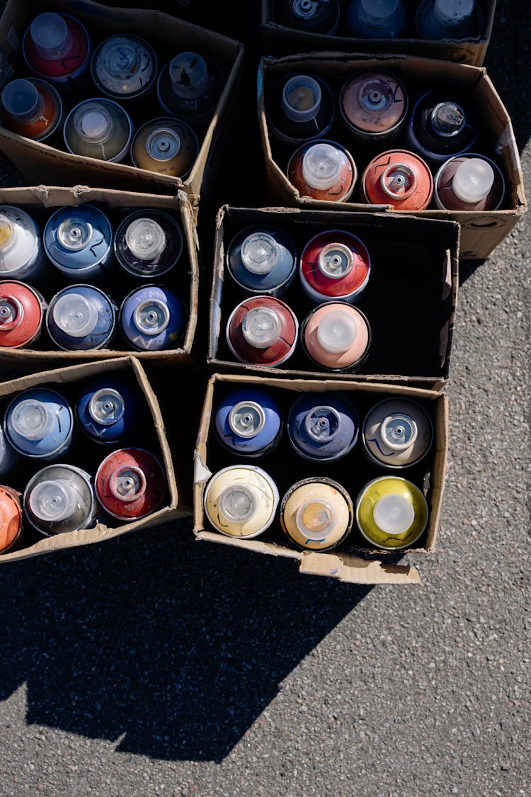 Close-Up Shot Of Spray Paints In Boxes