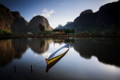 Free Tranquil scene of a traditional boat on a calm lake in South Sulawesi, Indonesia. Stock Photo