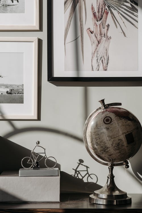 A Globe beside Picture Frames