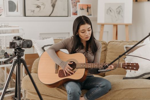 A Young Woman Vlogging Her Talent in Music