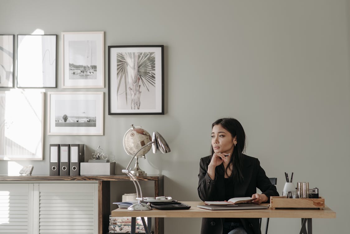 Free A Woman in Black Blazer Sitting on a Chair Stock Photo