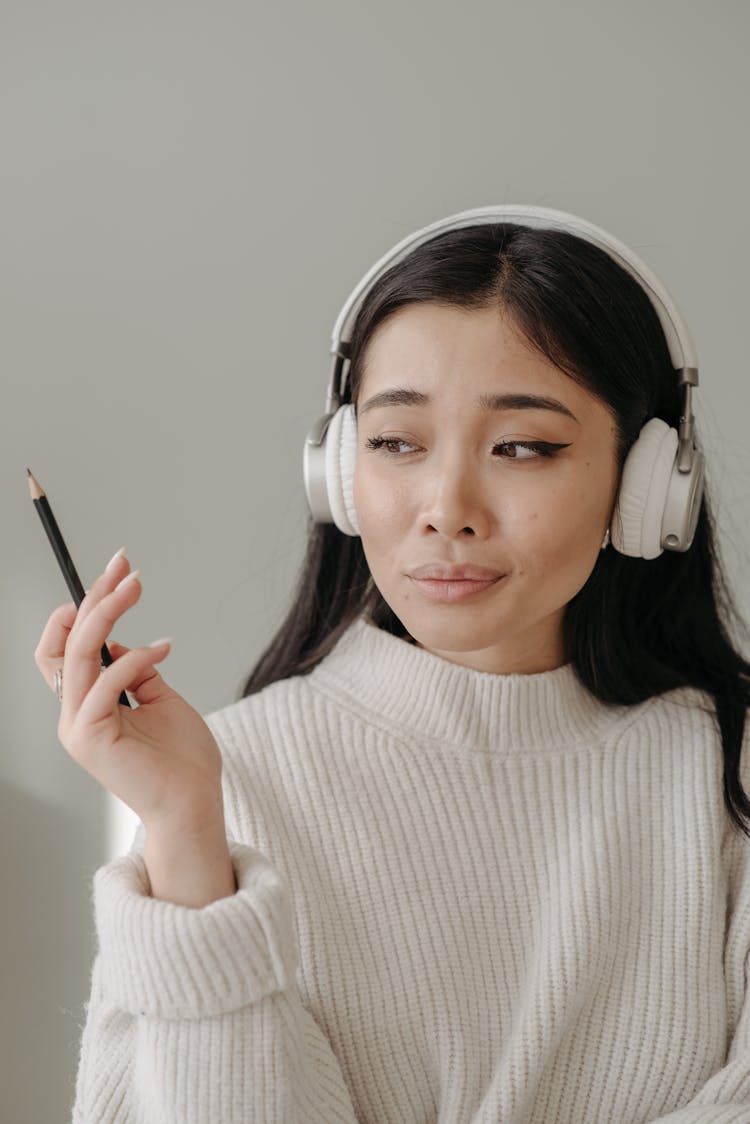 Woman In White Turtleneck Sweater Holding Black Pen