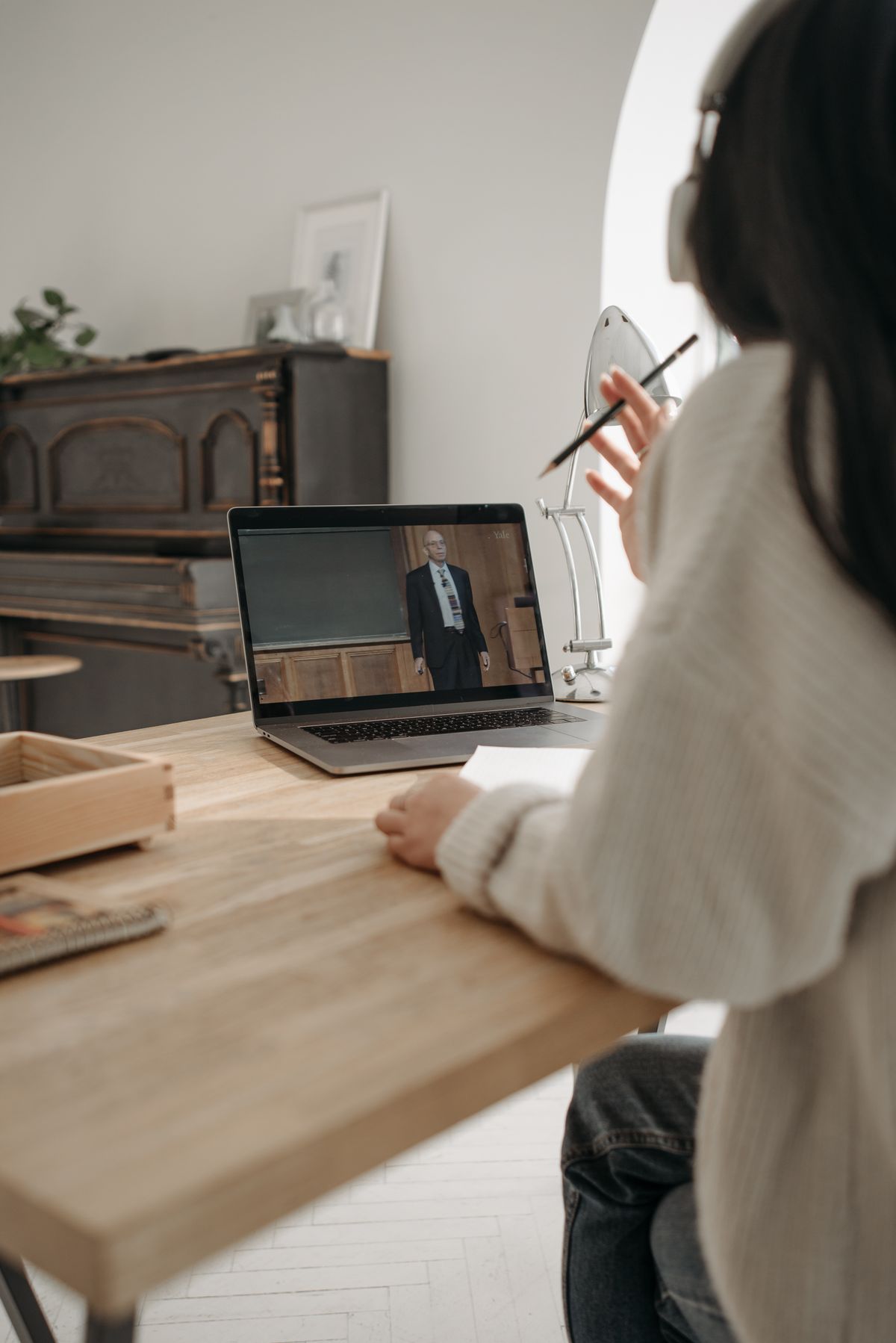 Professional learner taking notes during an online course