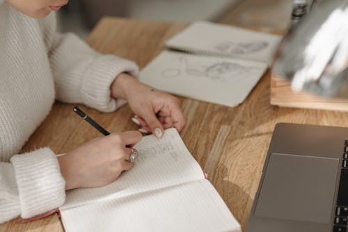 A Person Writing on White Paper