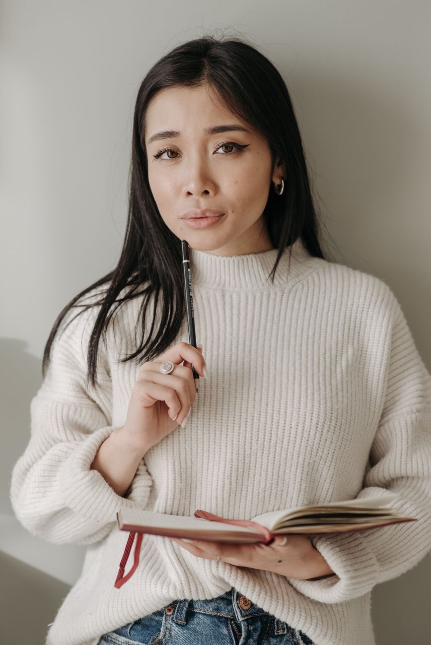 portrait of a smiling writer in a knit sweater