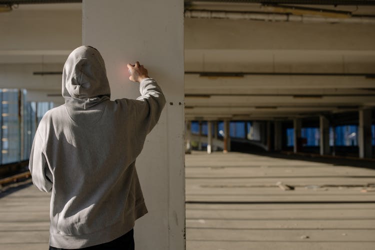 Man Wearing Grey Jumper On A Parking