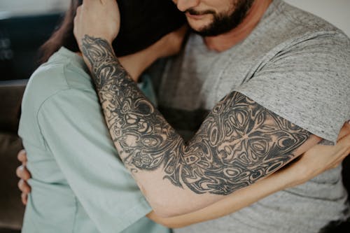 Man in Gray Shirt With Black Tattoo on Arm